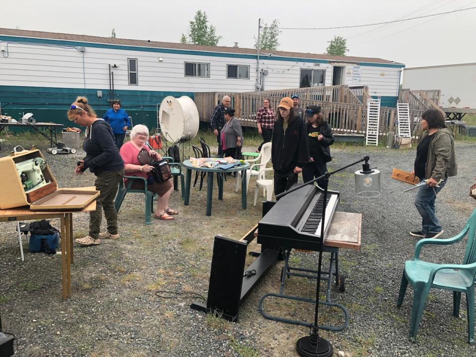 People checking out the wares at the ReStore next to Yellowknife's dump. The site had a couple of trailers and sea cans with a wide range of goods for sale.