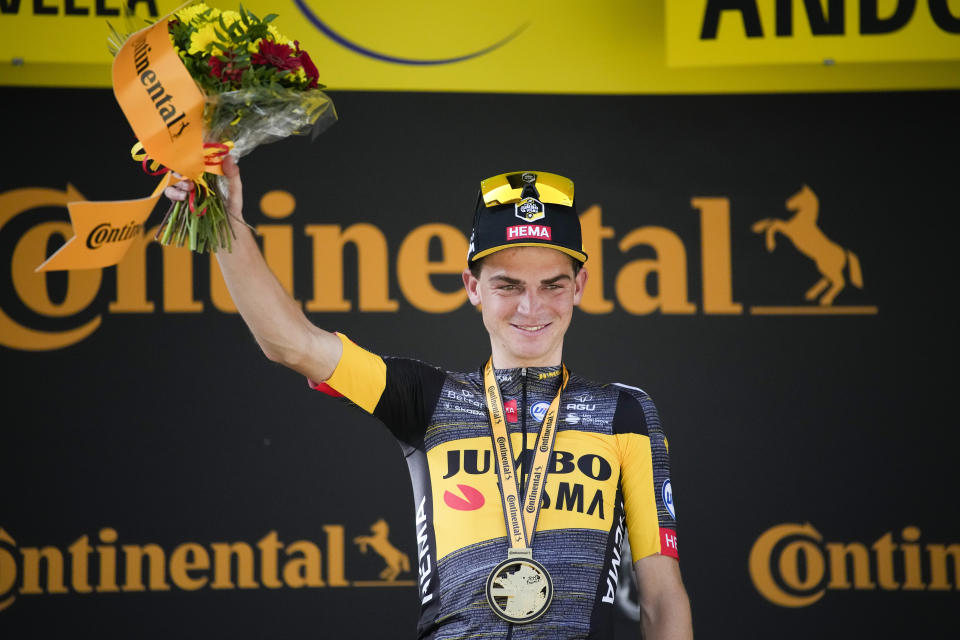 Stage winner Sepp Kuss of the US celebrates on the podium after the fifteenth stage of the Tour de France cycling race over 191.3 kilometers (118.9 miles) with start in Ceret and finish in Andorra-la-Vella, Andorra, Sunday, July 11, 2021. (AP Photo/Christophe Ena)