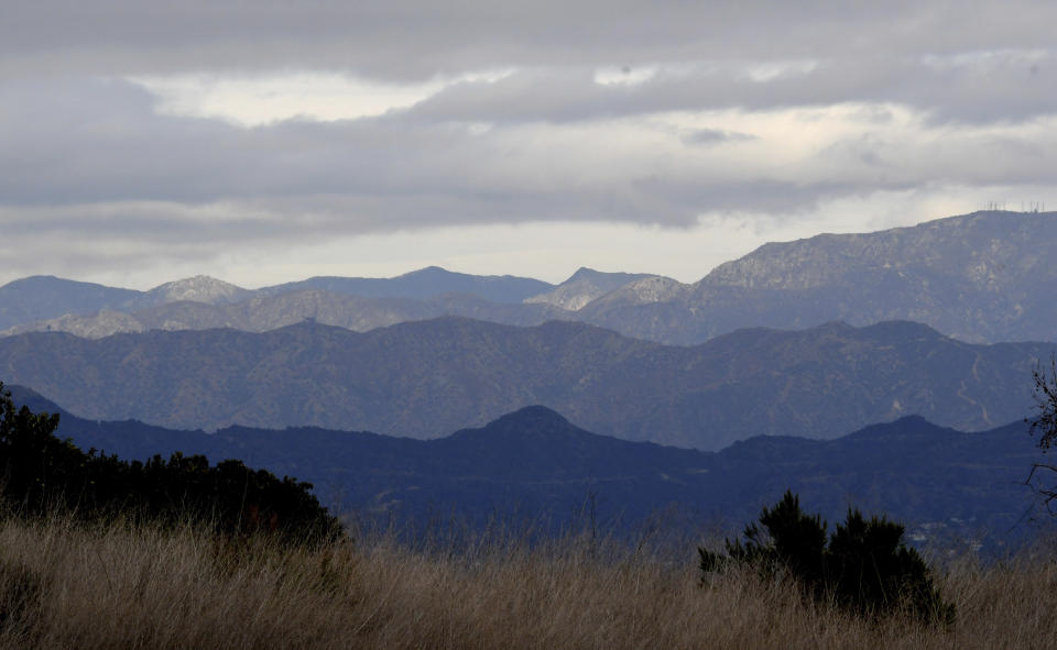 Clouds and shadows fall over the mountain from Kenneth Hahn State Park in Los Angeles, Wednesday, Jan. 27, 2021. Wide areas of the state remained under warnings and watches for flooding, heavy snow and winds. (Keith Birmingham/The Orange County Register/SCNG via AP)