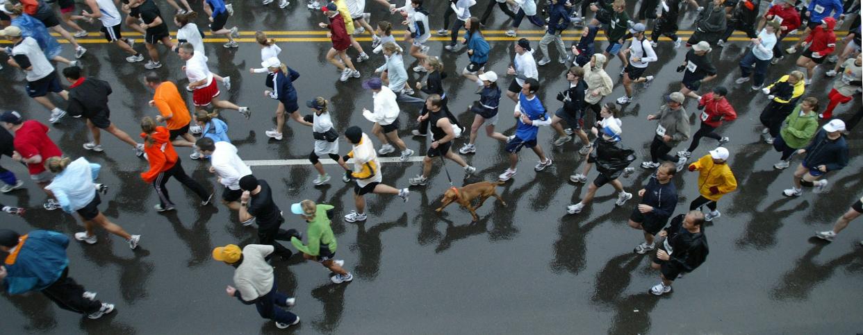 Half-marathon and 8-kilometer participants run along Forest Avenue in front of Drake Stadium during the Drake on the Road event of the Drake Relays on Saturday, April 28, 2006.
