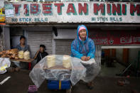 <p>Pema Kyi, a 40-year-old exile Tibetan, sells Tibetan bread by the roadside in Dharmsala, India, Tuesday, June 20, 2017. Pema, who lives alone, came into exile seven years ago and supports herself by baking and selling bread. (Photo: Ashwini Bhatia/AP) </p>