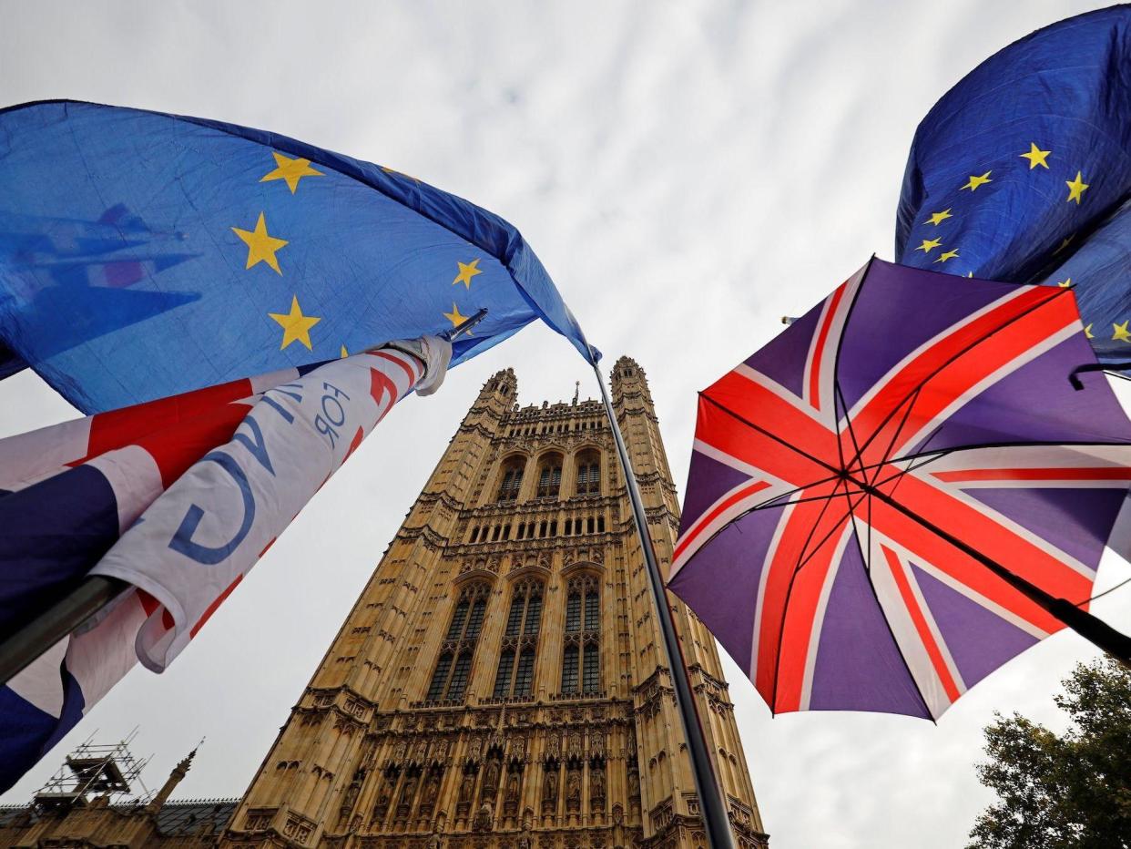 EU flag and Union flag-themed umbrellas of Brexit activists fly outside the Houses of Parliament in London on October 23, 2019: TOLGA AKMEN/AFP via Getty Images