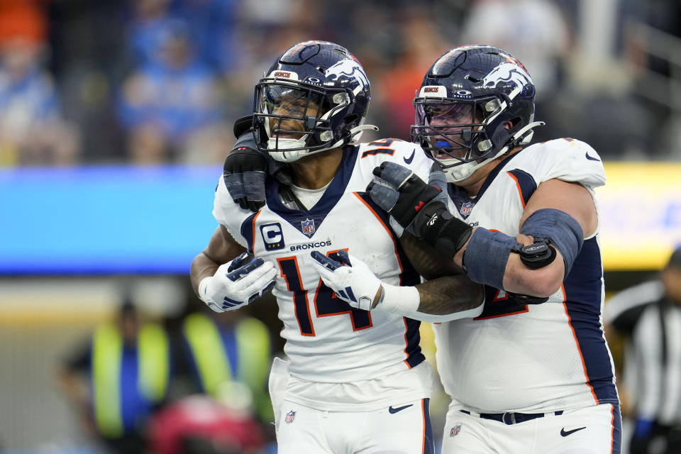 Denver Broncos wide receiver Courtland Sutton (14) celebrates his touchdown with offensive tackle Garett Bolles during the second half of an NFL football game against the Los Angeles Chargers Sunday, Dec. 10, 2023, in Inglewood, Calif. (AP Photo/Marcio Jose Sanchez)