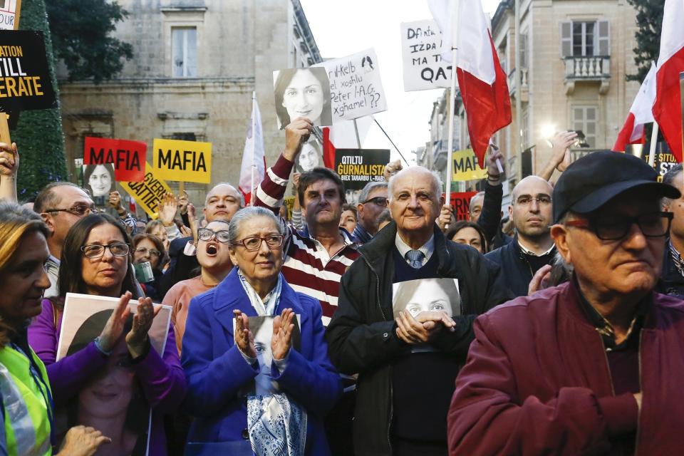 Rose Vella, center left, mother of late Daphne Caruana Galizia, and father of Daphne, Michael Vella, attend a protest in La Valletta, Malta, Sunday, Dec. 1, 2019. Malta's embattled prime minister has received a pledge of confidence from Labor Party lawmakers amid demands for his resignation by citizens angry over alleged links of his former top aide to the car bomb killing of a Maltese anti-corruption journalist. Hours later, thousands of Maltese protested outside a courthouse demanding that Joseph Muscat step down. (AP Photo)