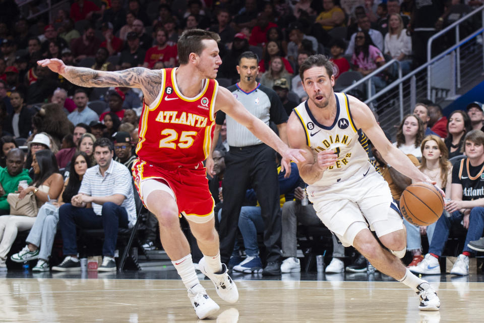 Indiana Pacers guard T.J. McConnell drives to the basket against Atlanta Hawks guard Garrison Mathews during the second half of an NBA basketball game, Saturday, March 25, 2023, in Atlanta. (AP Photo/Hakim Wright Sr.)