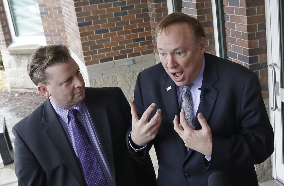 Sen. Todd Weiler, R-Woods Cross, left, and Sen. Jim Dabakis, D-Salt Lake City, speak to reporters in the doorway of Uintah Elementary School before stoping in for school lunch Thursday, Jan. 30, 2014, in Salt Lake City. A school district apologized Thursday to outraged parents after about 30 students at a Salt Lake City school had their lunches thrown out because of outstanding balances on their food accounts. Salt Lake City School District spokesman Jason Olsen said the district is investigating what happened at Uintah Elementary and working to make sure it doesn't happen again. "This was a mistake. This was handled wrong," Olsen said during a news conference outside the school. (AP Photo/Rick Bowmer)