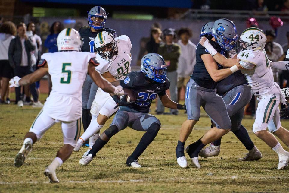 Chandler Wolves running back Ca'lil Valentine (22) looks for an opening in the Basha Bear defensive line at Austin Field in Chandler on Friday, Oct. 28, 2022.