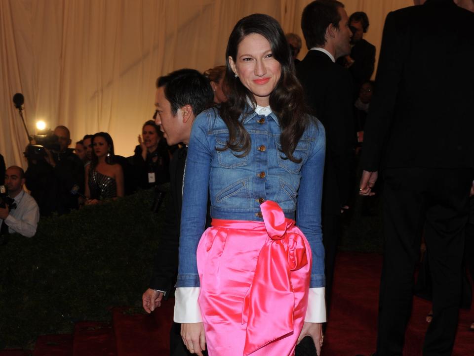 Jenna Lyons at the 2012 Met Gala wearing a denim jacket and pink silk maxi skirt.