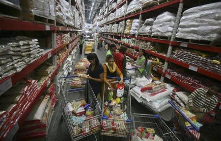 Customers shop inside a Best Price Modern Wholesale store, a joint venture of Wal-Mart Stores Inc and Bharti Enterprises, at Zirakpur in Punjab November 24, 2012. REUTERS/Ajay Verma/Files