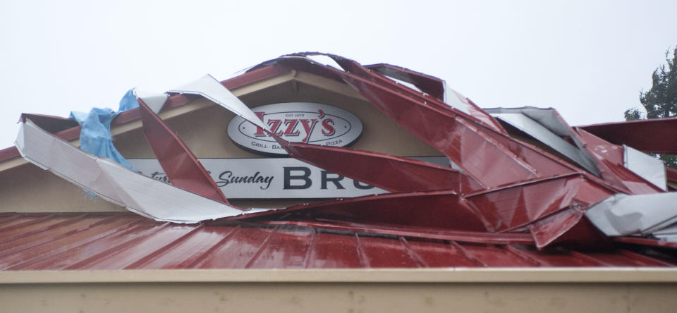 Sections of Izzy's restaurant roof have been torn off overnight in high winds that have hit the Oregon coast in Newport, Ore., Monday, Nov. 19, 2012. (AP Photo/The Oregonian, Brent Wojahn)