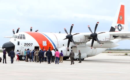 Prime Minister Hubert MInnis boards a U.S. Coast Guard plane, en route to Abaco for a reconnaissance flight to survey damage caused by Hurricane Dorian, in Nassau, Bahamas