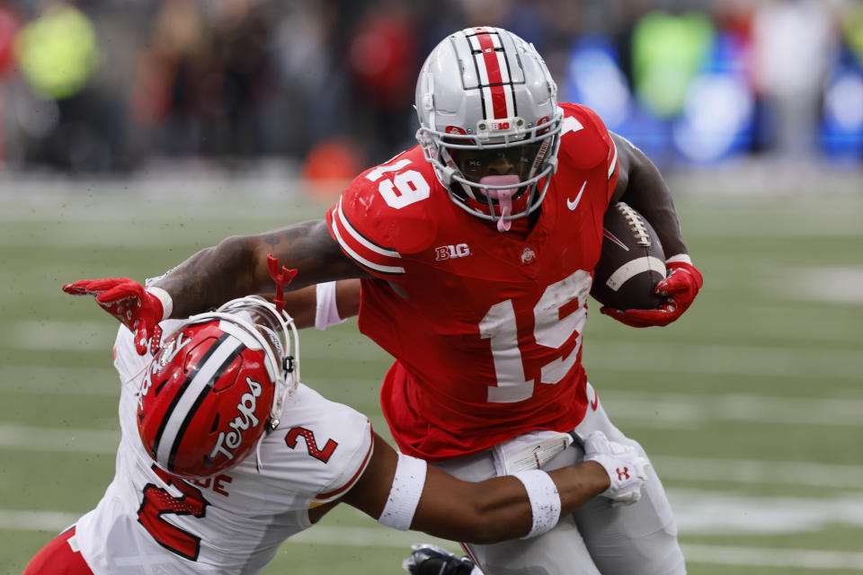 Ohio State running back Chip Trayanum, right, stiff arms Maryland defensive back Beau Brade during the first half of an NCAA college football game Saturday, Oct. 7, 2023, in Columbus, Ohio. (AP Photo/Jay LaPrete)