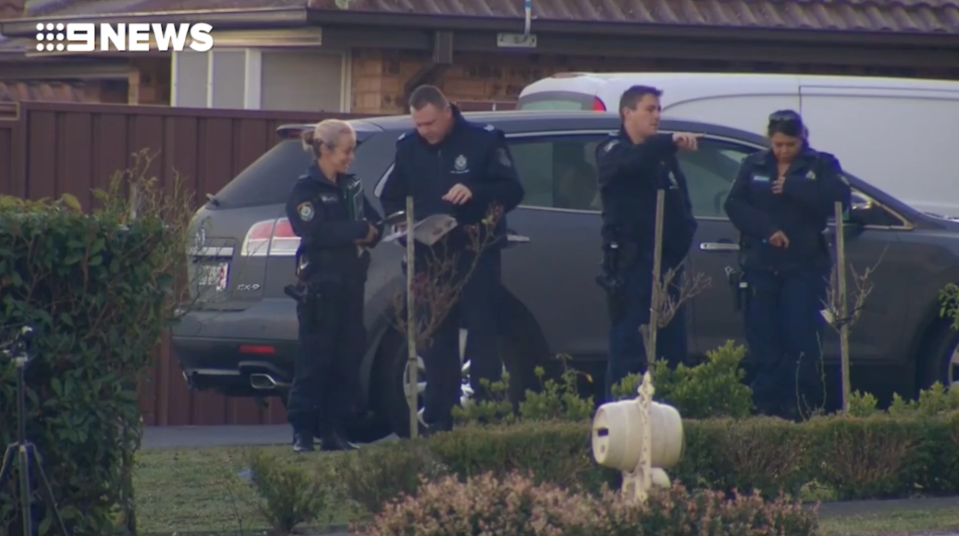 Police study the scene at day break after a woman was decapitated in St Clair, allegedly by her daughter, on Saturday night.