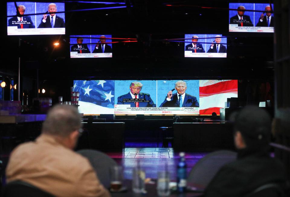 People are pictured watching the final debate between President Donald Trump and Democratic presidential nominee Joe Biden at The Abbey in West Hollywood, California.