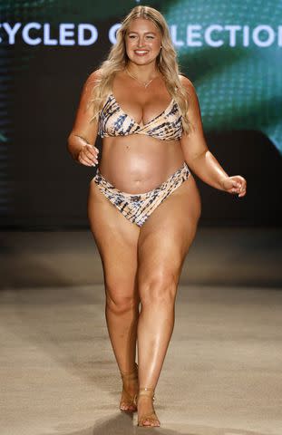 <p> Frazer Harrison/Getty</p> Iskra Lawrence models tie-dye two-piece during Cupshe's runway show at Miami Swim Week