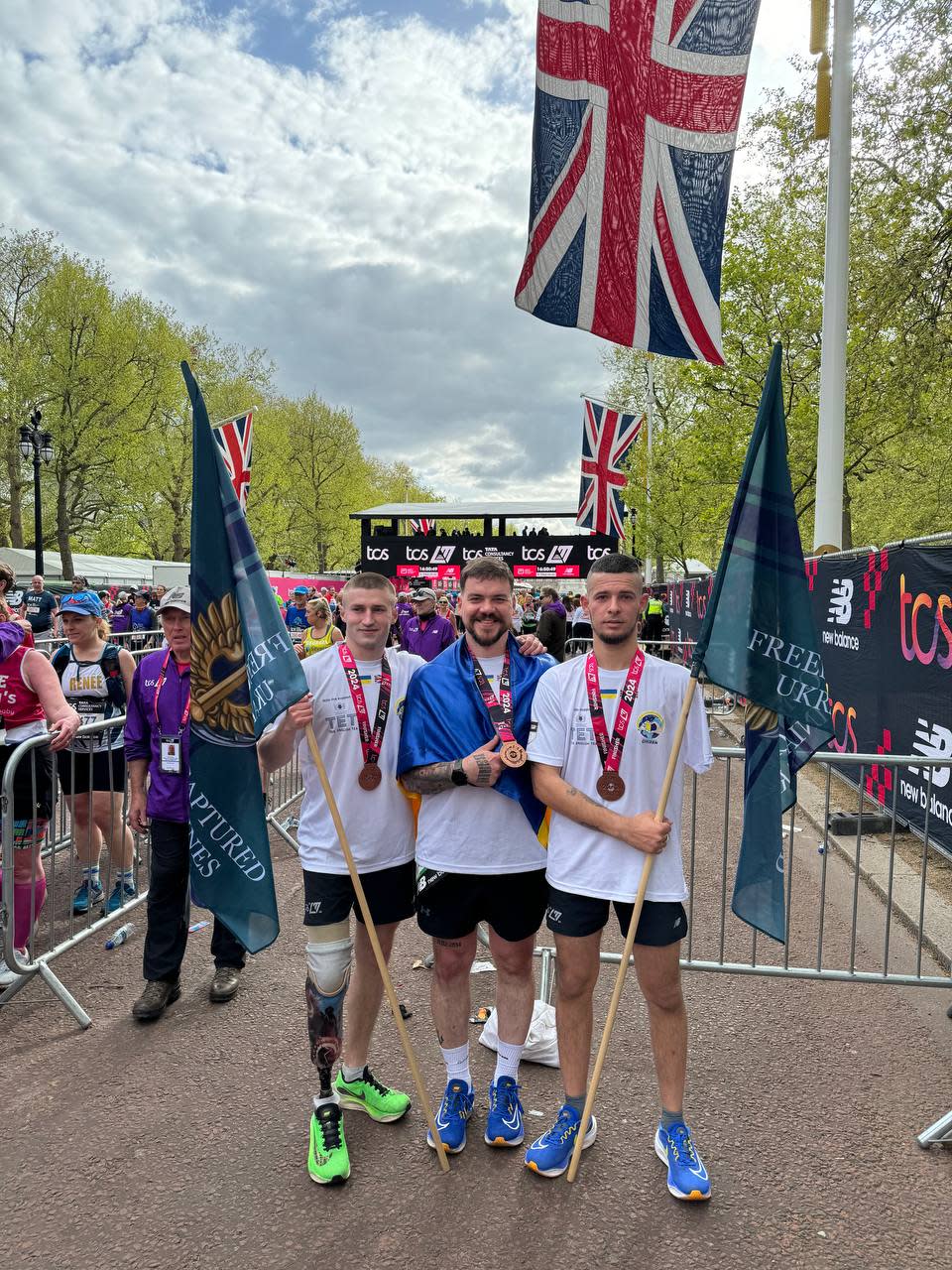 The men at the London Marathon holding flags 