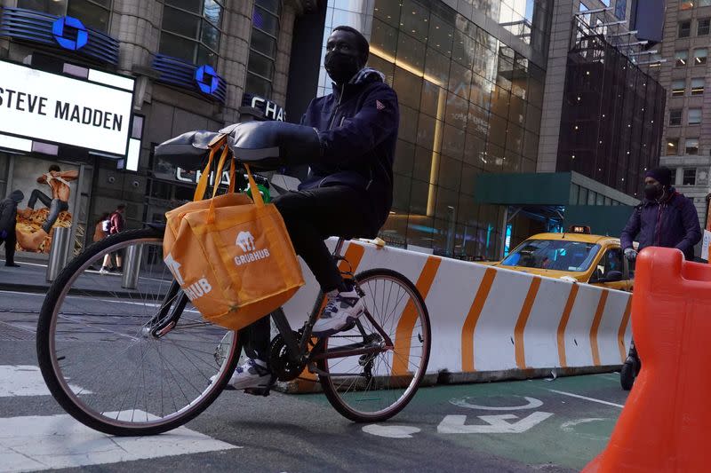 FILE PHOTO: A Grubhub delivery person rides in Manhattan, New York City