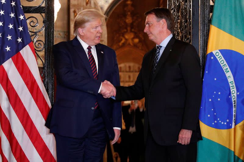 U.S. President Donald Trump shakes hands with Brazilian President Jair Bolsonaro before attending a working dinner at the Mar-a-Lago resort in Palm Beach, Florida