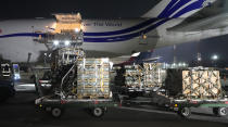 Workers unload a shipment of military aid delivered as part of the United States of America's security assistance to Ukraine, at the Boryspil airport, outside Kyiv, Ukraine, Tuesday, Jan. 25, 2022. A new batch of US security assistance provided to Ukraine, including equipment and ammunitions, arrives at the Boryspil airport. The U.S. moves are being done in tandem with actions by other NATO member governments to bolster a defensive presence in Eastern Europe. (AP Photo/Efrem Lukatsky)