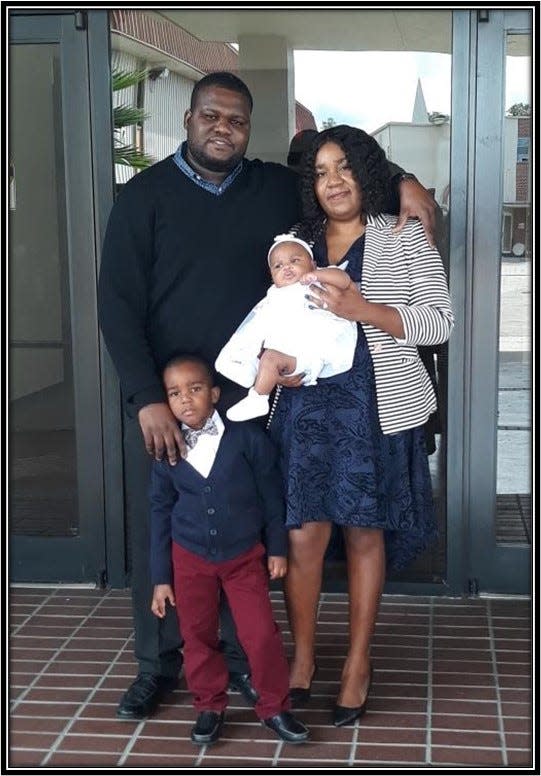 Rodner and Anne Valentin Saint Brave pose with their children, David and Chrisha Joanna, in Orlando, Florida, in 2019.