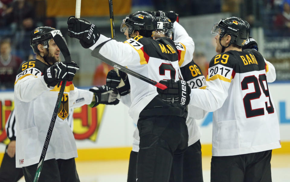 Germany players celebrates their goal during the Group B preliminary round match between Germany and Latvia at the Ice Hockey World Championship in Minsk, Belarus, Sunday, May 11, 2014. (AP Photo/Darko Bandic)