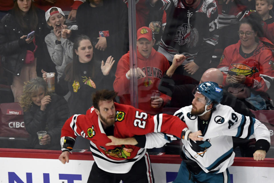 Chicago Blackhawks' Jarred Tinordi (25) fights San Jose Sharks' Scott Sabourin (49) during the second period of an NHL hockey game Tuesday, Jan 16, 2024, in Chicago. (AP Photo/Paul Beaty)