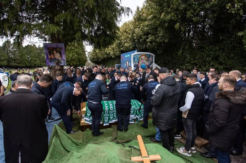 The coffin was covered with Irish scarves before being lowered into the ground