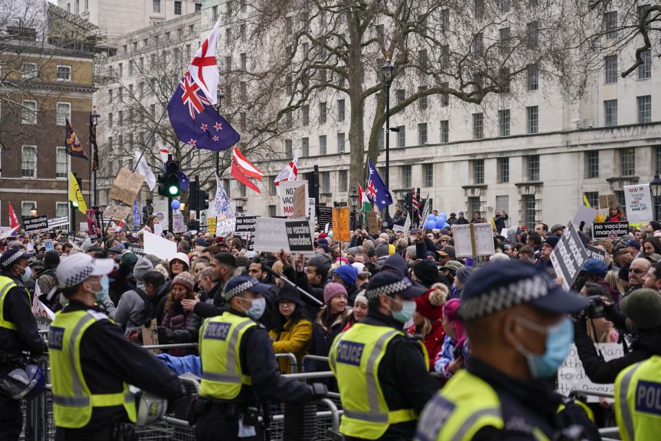 Demonstrators march outside Downing Street, during an anti vaccines protest, in London, Saturday, Jan. 22, 2022.(AP Photo/Alberto Pezzali)