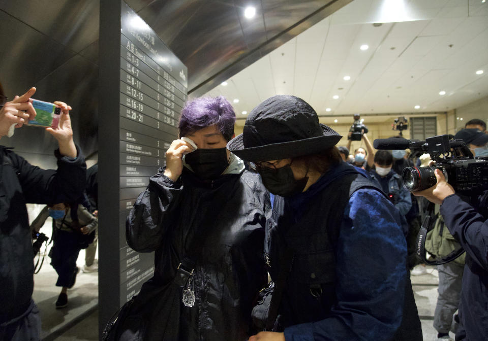 A reltive of one of the 47 pro-democracy activists reacts outside a court in Hong Kong Thursday, March 4, 2021. A Hong Kong court on Thursday remanded all 47 pro-democracy activists charged under a Beijing-imposed national security law in custody, ending a four-day marathon court hearing. (AP Photo/Vincent Yu)