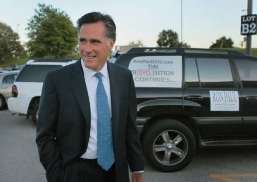 Former Massachusetts Governor Mitt Romney arrives at the Stephens Auditorium at Iowa State University for the Republican party debate August 11 in Ames, Iowa. Republicans will make the 2012 election a referendum on Obama's economic management, and their frontrunner, Romney, seized the chance to poke his possible general election opponent