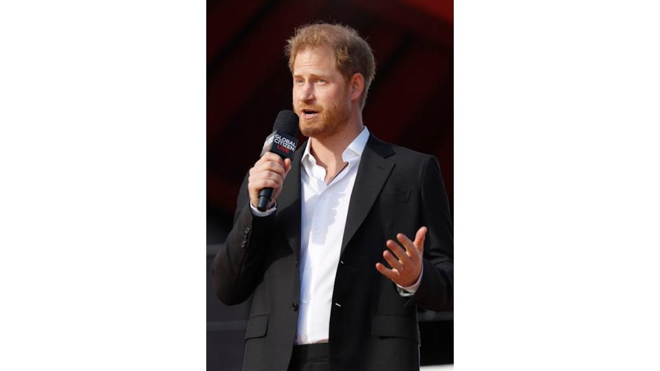 Prince Harry holding a microphone