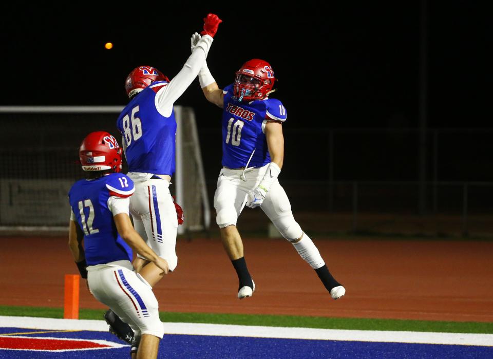 Mountain View's Reese Marziale (10) celebrates his touchdown with teammate Jackson Bowers (86) during a 6A playoff game at Mountain View High School on Nov. 19, 2021.