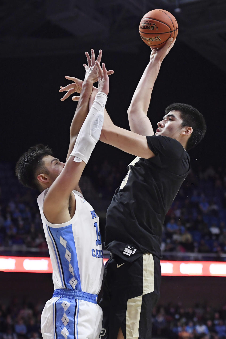 Purdue's Zach Edey, right, shoots over North Carolina's Dawson Garcia in the second half of an NCAA college basketball game, Saturday, Nov. 20, 2021, in Uncasville, Conn. (AP Photo/Jessica Hill)