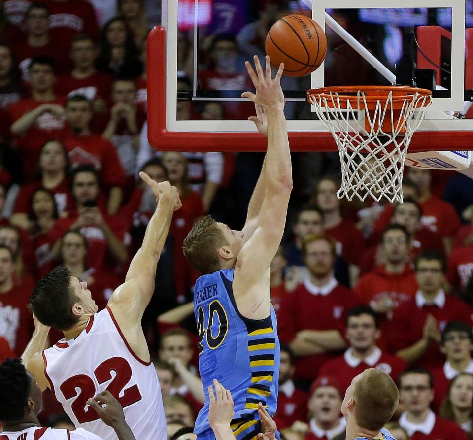 Marquette center Luke Fischer tips in the winning basket with 26 seconds left during Marquette's 57-55 win over Wisconsin in 2015 in Madison.