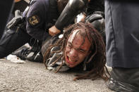 Louisville police detain a man after a group marched after a grand jury indicted one officer on criminal charges six months after Breonna Taylor was fatally shot by police in Kentucky, Wednesday, Sept. 23, 2020, in Louisville, Ky. Protests against racial injustice aren't just part of the United States' national conversation. America's foes have taken note too, using the demonstrations and images of police violence to criticize the country at the U.N. General Assembly this year. (AP Photo/John Minchillo)