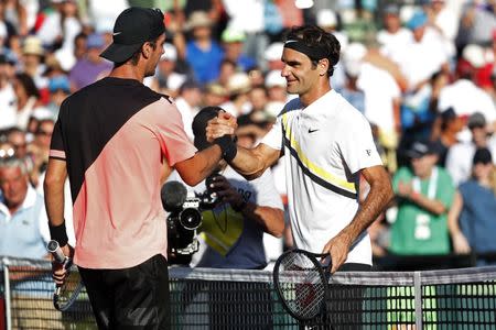 Mar 24, 2018; Key Biscayne, FL, USA; Thanasi Kokkinakis of Australia (L) shakes hands with Roger Federer of Switzerland (R) after their match on day five of the Miami Open at Tennis Center at Crandon Park. Kokkinakis won 3-6, 6-3, 7-6(4). Mandatory Credit: Geoff Burke-USA TODAY Sports