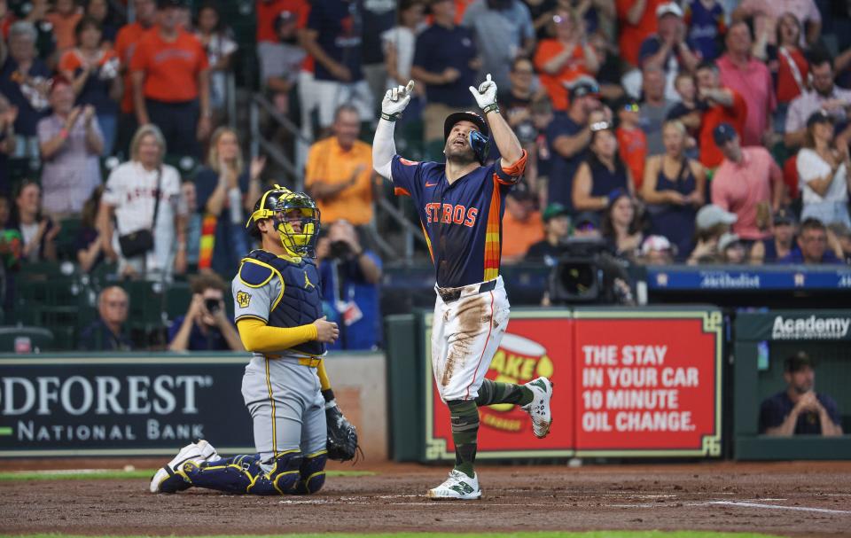 Astros second baseman Jose Altuve crosses home plate after hitting a home run during the first inning.