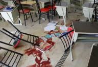 A picture shows the blood stained floor of a class room following rocket attacks carried out by Syrian rebels in the Shahba neighbourhood of the government-held side of Aleppo on October 27, 2016