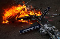 <p>A road sign is on fire during a protest on July 7, 2017 in Hamburg, northern Germany, where leaders of the world’s top economies gather for a G20 summit. (Photo: Ronny Hartmann/AFP/Getty Images) </p>