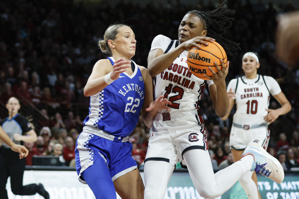 South Carolina guard MiLaysia Fulwiley (12) drives into Kentucky guard Maddie Scherr (22) during the first half of an NCAA college basketball game in Columbia, S.C., Monday, Jan. 15, 2024. (AP Photo/Nell Redmond)