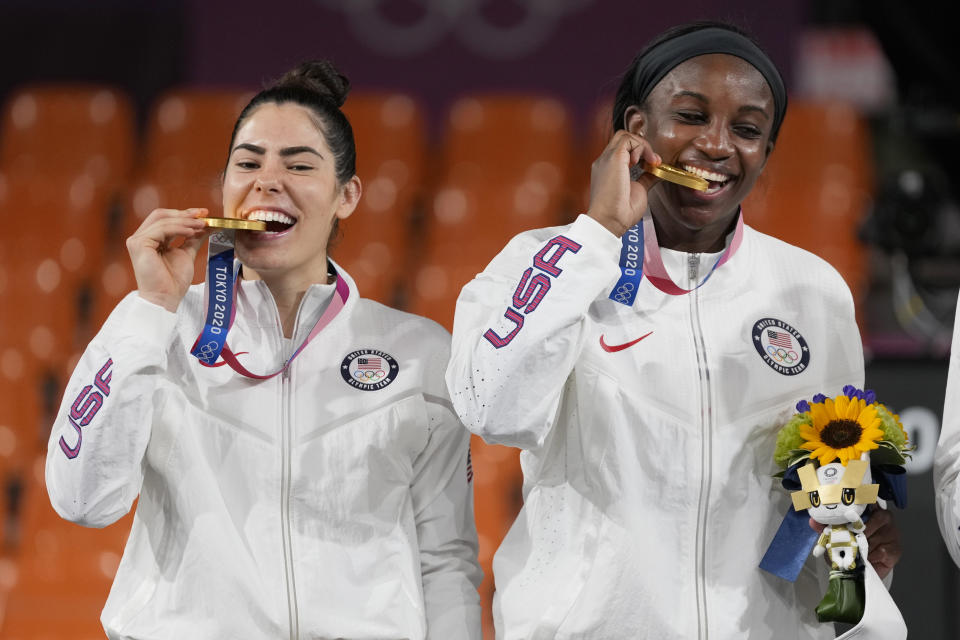 Members of team United States Kelsey Plum, left, and Jacquelyn Young pose with their gold medals during the awards ceremony for women's 3-on-3 basketball at the 2020 Summer Olympics, Wednesday, July 28, 2021, in Tokyo, Japan. (AP Photo/Jeff Roberson)