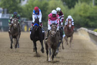 Flavien Prat atop Rombauer, center, reacts after winning the Preakness Stakes horse race at Pimlico Race Course, Saturday, May 15, 2021, in Baltimore. (AP Photo/Nick Wass)