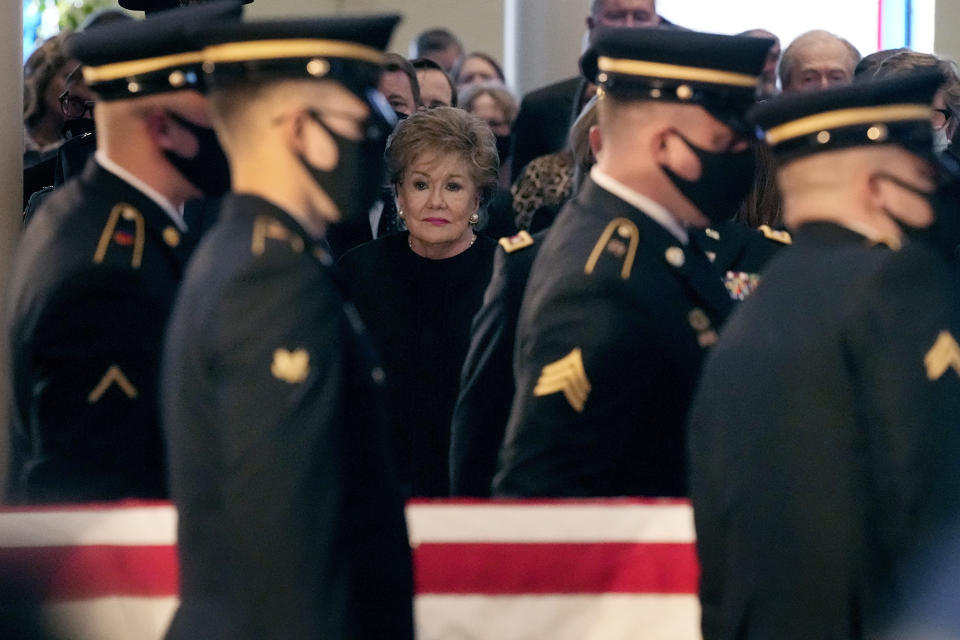 Former Sen. Elizabeth Dole watches while the casket holding her husband, former Sen. Bob Dole, R-Kan., is carried after a memorial service, Saturday, Dec. 11, 2021, in Russell, Kan. (AP Photo/Charlie Riedel)