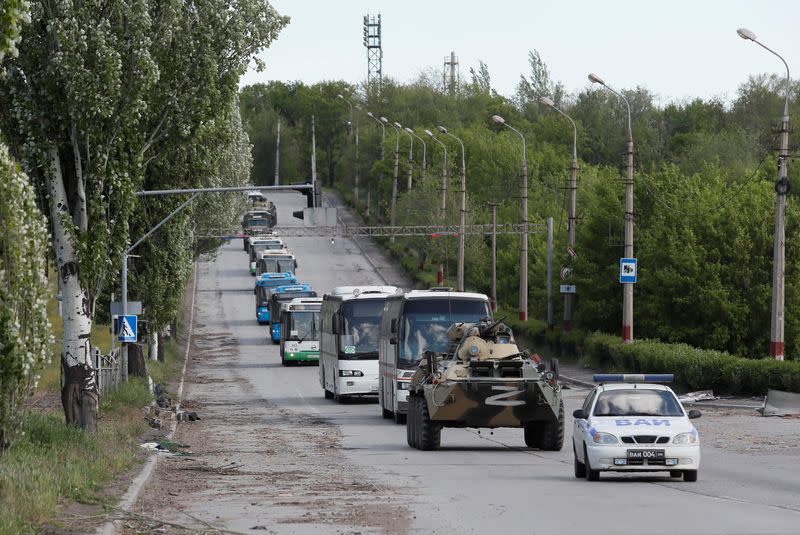 Buses carrying service members of Ukrainian forces who have surrendered after weeks holed up at Azovstal steel works leave Mariupol