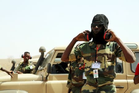 A Senegalese soldier puts on ear muffs ahead of a car bomb explosion during the U.S.-led "Flintlock" training exercises for African militaries, in Thies, Senegal February 18, 2016. REUTERS/Emma Farge