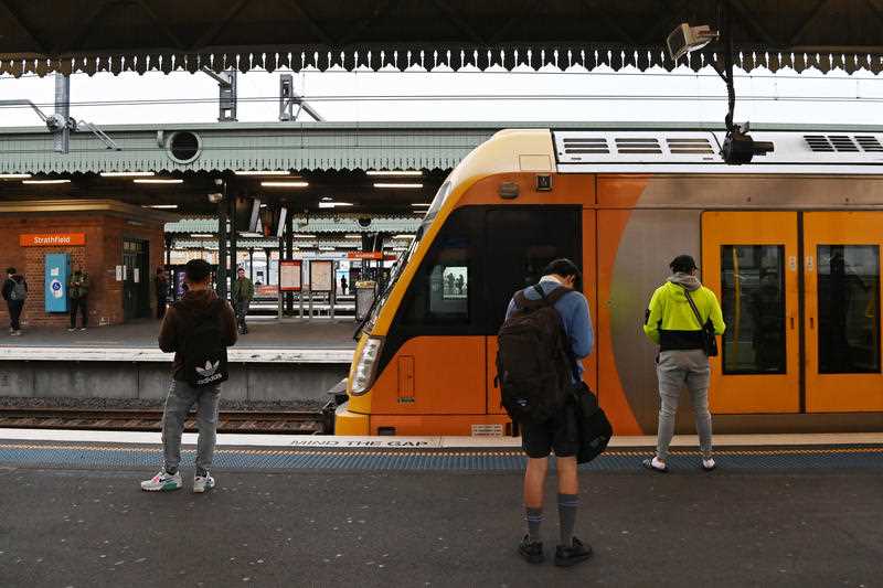 Commuters and school students return to public transport at Strathfield Train Station in Sydney.