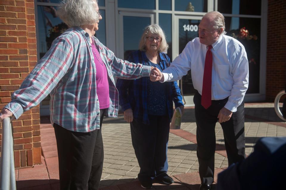 Uniontown residents and activist Ellis Long and Mary Schaeffer talk to ADEM director Lance Lefleur during a protest outside Alabama Department of Environmental Management in Montgomery, Ala., on Thursday, Dec. 15, 2022.