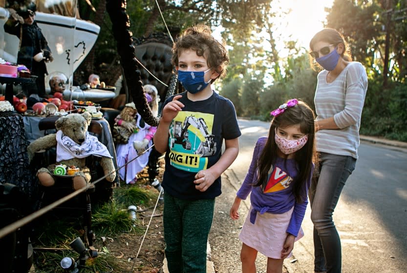 BRENTWOOD, CA - OCTOBER 28: A family visits a home in Brentwood goes all out with Hollywood-caliber halloween decorations on Wednesday, Oct. 28, 2020 in Brentwood, CA. (Jason Armond / Los Angeles Times)