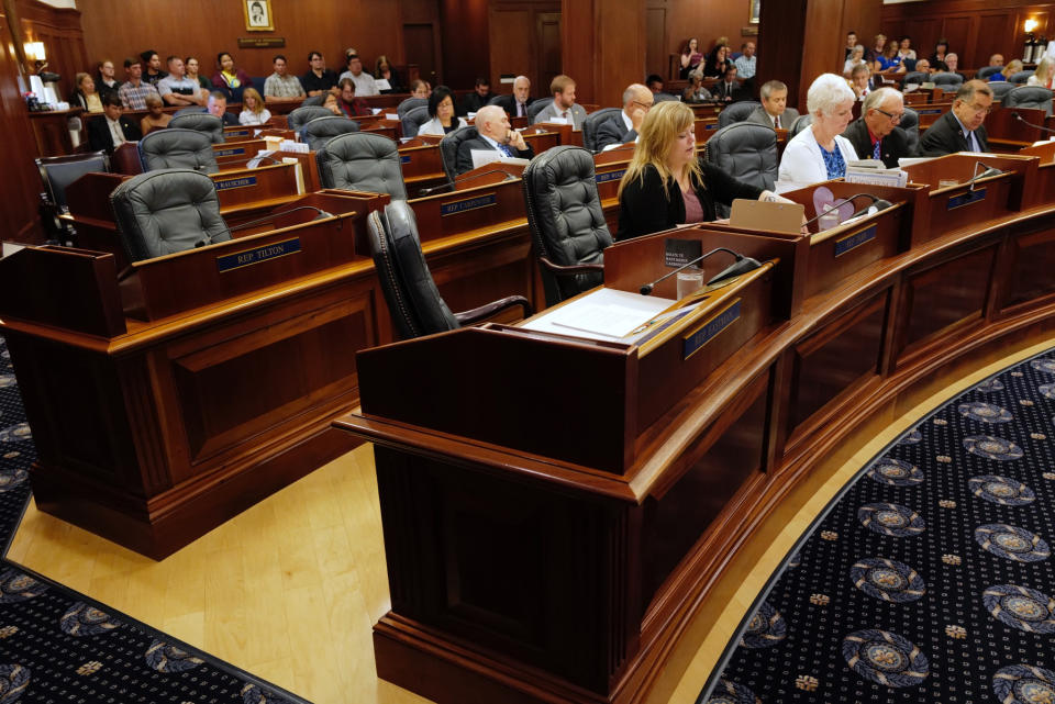 Empty seats are seen at a joint session of the Alaska Legislature, called to consider overriding Gov.Mike Dunleavy's budget vetoes Wednesday, July 10, 2019, Juneau, Alaska. Nearly a third of lawmakers were absent from the session at the Capitol, opting to meet in Wasilla instead, leaving only 38 members meeting in Juneau. It would take 45 votes to override the vetoes. (Michael Penn/Juneau Empire via AP)