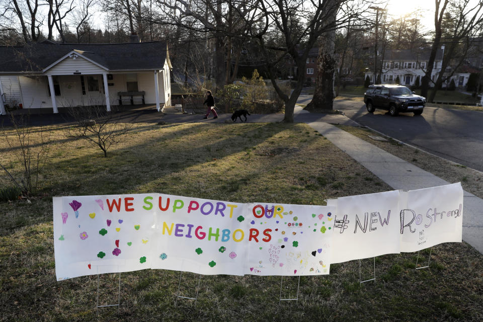 A sign showing support for residents is displayed on a lawn in New Rochelle, N.Y., Wednesday, March 11, 2020. State officials are shuttering several schools and houses of worship for two weeks in the New York City suburb and sending in the National Guard to help with what appears to be the nation's biggest cluster of coronavirus cases, Gov. Andrew Cuomo said Tuesday. (AP Photo/Seth Wenig)